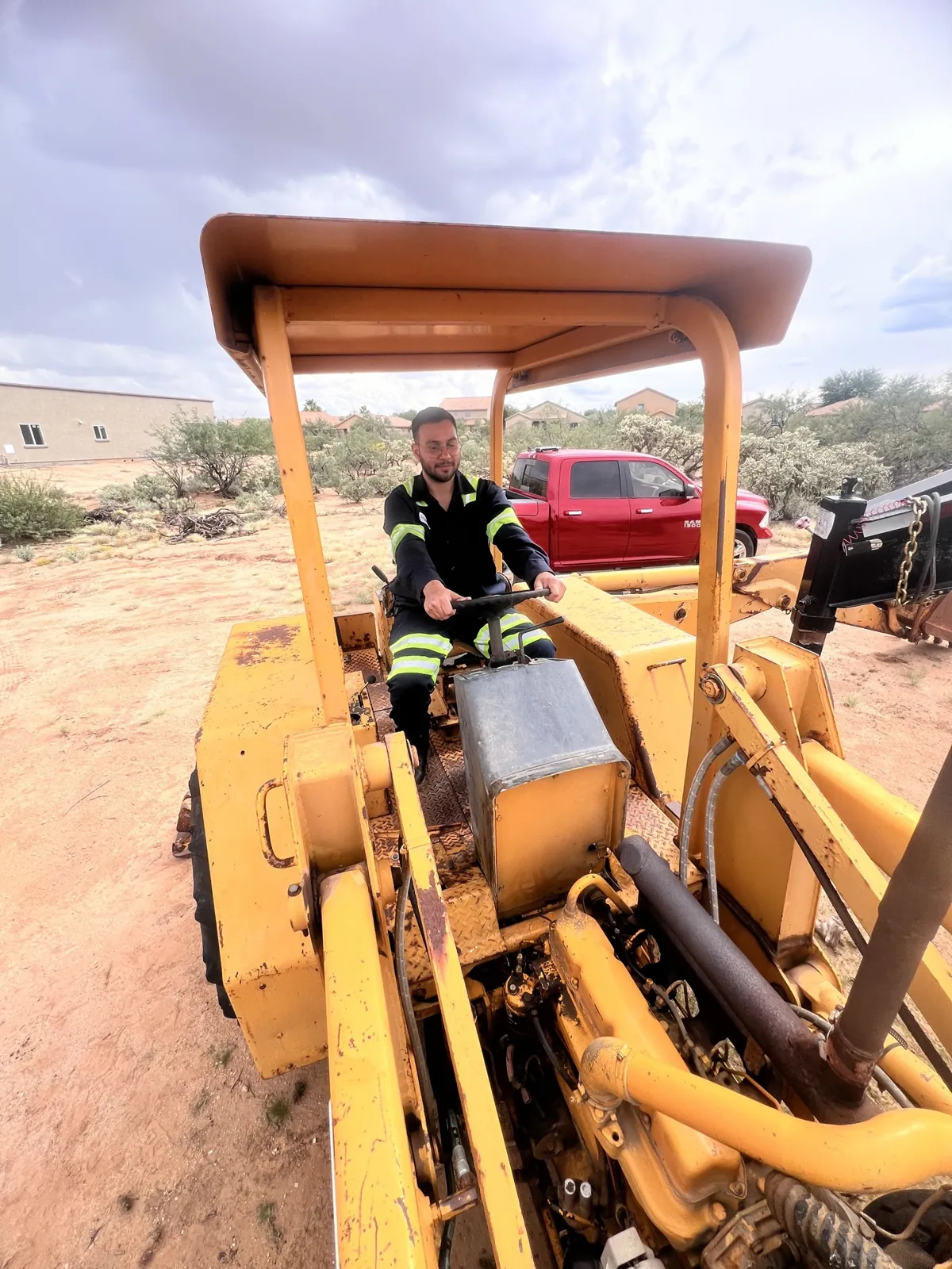 Heavy equipment repair in Tucson - mechanic servicing a yellow wheel loader